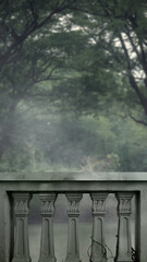 Outdoor view of balustrade railing on the balcony overlooking a blurred forest. The scene is scary and mysterious. Dramatic smoke or fog effect. Mockup. Copy Space. Wallpaper or Halloween background