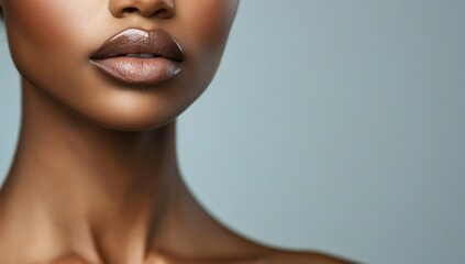 Close-up of a person's lips and neck with glossy lipstick on a light blue background