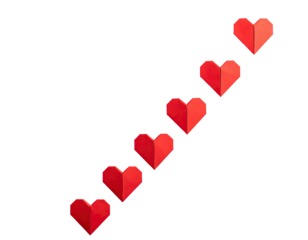 Seven red origami hearts in diagonal line against black