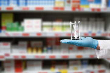 Doctors hands holding hourglass clock