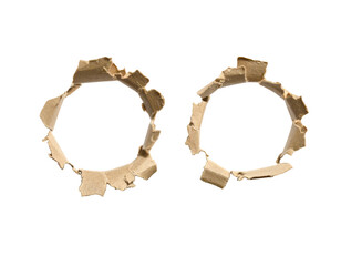 Two circular holes punched through light beige cardboard, ragged edges