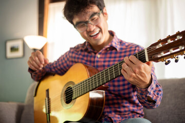 music,artist musician playing acoustic guitar.people relaxing time with instrument singing,songwriter thinking writing notes,lyrics,composer work