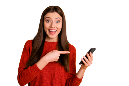 Photo of cheerful attractive overjoyed cute trendy youngster pointing at her telephone expressing amazement with face wearing red sweater isolated over vivid color background