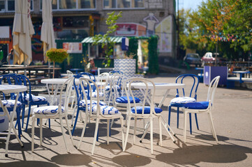 outdoor cafe seating with blue and white chairs