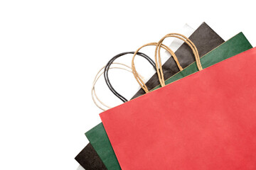 Top view set collection stack of colorful paper shopping bags or tote bags on a white background. Mockup, template, or copy space