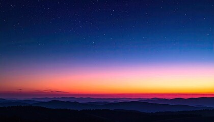 Fototapeta premium Night sky meets colorful sunrise over misty mountains