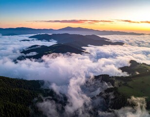 Obraz premium Sunrise over misty mountain ranges (1)