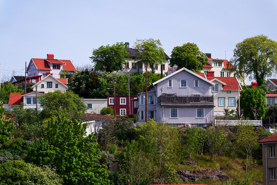 Picturesque colony of old small wooden historic houses on the Slottsberget mountain on the banks of the Gota alv river, Gothenburg, Sweden, sunny day