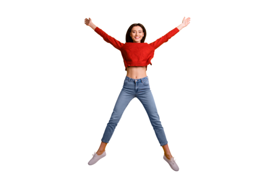 Full size photo of positive cheerful pretty millennial girl jump raise her hands like wings star have fun on vacation free time wear good looking clothes pullover isolated over yellow color background
