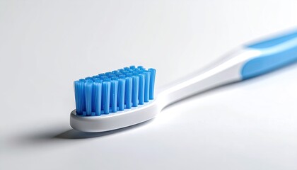 Close-up of a toothbrush head, blue bristles, white handle