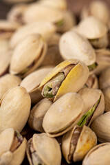 unpeeled pistachio nuts fried in salt, pistachios after roasting with cracked shells