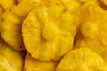 dried ripe bright yellow pineapple fruits close up, cut into rings and dried yellow clean slices of ripe pineapple for long-term storage and used as a sweet