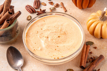  Pumpkin Spice Greek Yogurt in glass bowl, with spices, cinnamon, healthy autumn snack with traditional fall season taste, protein and calcium source