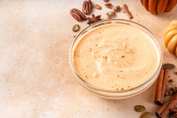  Pumpkin Spice Greek Yogurt in glass bowl, with spices, cinnamon, healthy autumn snack with traditional fall season taste, protein and calcium source
