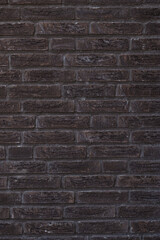Vertical dark brown background of a brick wall