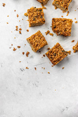 Golden baked flapjacks cut into squares on parchment, styled as a homemade sweet snack or dessert bar concept.