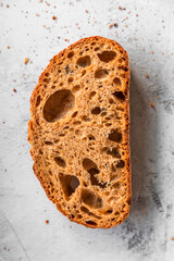 Sliced rye sourdough bread showing texture and crumb, styled as a fresh bakery or rustic food background.