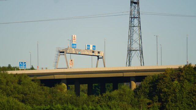 M4 Motorway Overpass Bridge at Junction 42 Fabian Way with Electricity Pylons with Trees Below.
