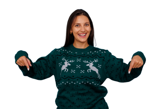 Woman in green christmas sweater pointing down on transparent background, smiling, presenting holiday offer