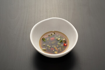 Authentic Thai Fish Sauce with chili and lime, a classic dipping condiment enhancing flavor in Thai...