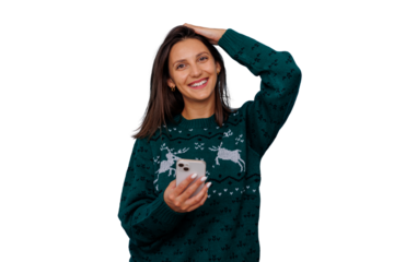 Young woman smiling, holding smartphone, wearing christmas sweater, celebrating winter holidays with transparent background