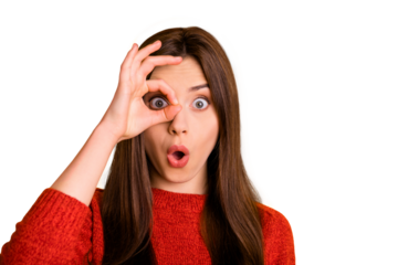 Close up photo of amazed astonished girl with her okay sign near eye look watch like spy see unbelievable ads feel stupor face expression wear red sweater isolated over yellow color background