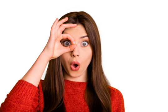 Close up photo of amazed astonished girl with her okay sign near eye look watch like spy see unbelievable ads feel stupor face expression wear red sweater isolated over yellow color background