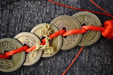 A Christmas deer figurine and Chinese Feng Shui coins.