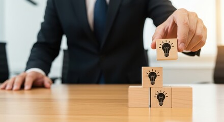 Businessman Assembling Wooden Blocks with Light Bulb Icons in Modern Office Environment for Creative Ideas Concept