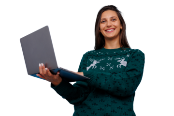 Woman in festive sweater holding laptop, smiling at camera. Displaying holiday spirit and digital connection with transparent background