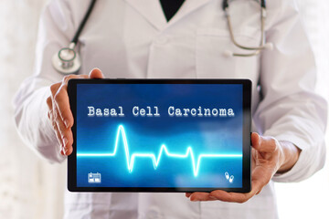 Medical terms. Basal cell carcinoma. Female doctor holding a digital tablet with words written on it