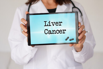 Medical terms. Liver Cancer. Female doctor holding a digital tablet with words written on it.