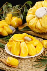 Fresh Yellow Jackfruit Segments Thailand Tropical Fruit Display with Juice Glass and Whole Fruit on Bamboo Mat