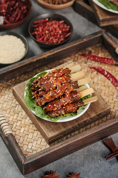 Chinese Grilled Beef Skewers with Sesame Seeds - Traditional Asian Barbecue Snacks on Wooden Serving Tray