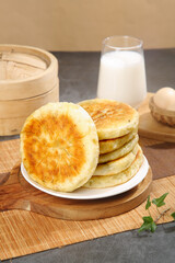 Homemade Golden Pan-Fried Pastries with Traditional Steamer Basket and Fresh Milk Kitchen Scene