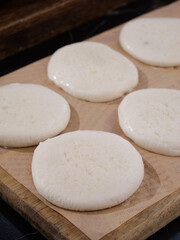 Hand-made glutinous rice cakes on wooden board - traditional Asian dessert preparation
