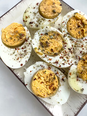 Halved Hard boiled eggs with spices and herbs on plate