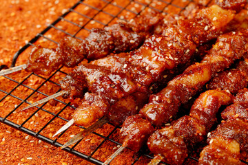 Gourmet Grilled Meat Kebabs Sizzling on Charcoal Grill with Golden Caramelized Glaze