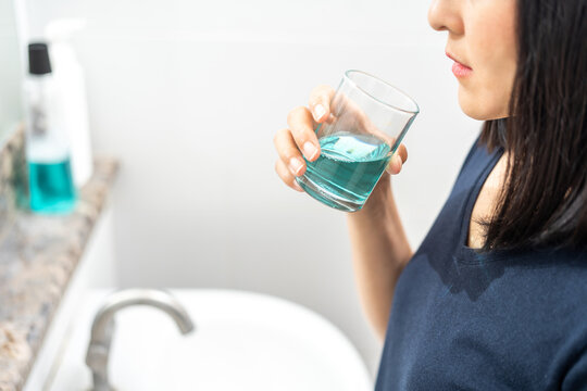 Woman healthy using mouthwash after brushing her teeth fresh breath. Oral hygiene routine for freshness breath, prevent plaque and gum disease. Dental health care Oral hygiene and teeth care concept.