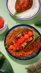 Handmade glutinous rice dumplings with salted egg yolk and meat filling wrapped in banana leaves on ceramic plates