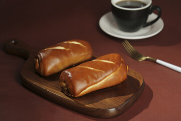 Handmade Lye Buns on Wooden Board with Coffee - Traditional Bakery Breakfast Food Photography