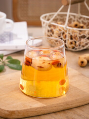Traditional Chinese Pitted Date Tea with Peeled Dates in Glass Cup on Wooden Board - Healthy Herbal Drink