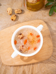White Fungus Soup with Dates and Carrots in Mug on Wood Board - Traditional Asian Healthy Dessert