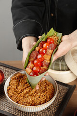 Handmade Asian Rice Dumplings with Pork and Sticky Rice in Bamboo Leaves - Traditional Dragon Boat Festival Food