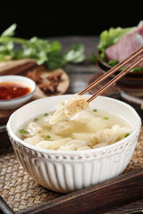 Handmade Wontons in Clear Broth - Traditional Asian Dumpling Soup with Chopsticks