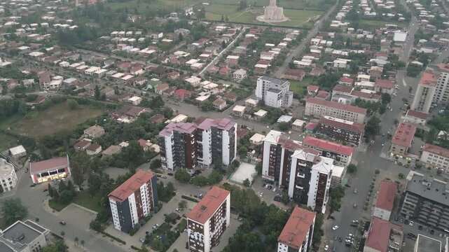 Aerial top down view new and old apartment blocks in Zugdidi residential district with cathedral background &mdash; concepts: real estate, housing, urban growth, investment, development, infrastructure