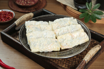 Handmade Vegetarian Spring Rolls with Fresh Vegetables on Traditional Bamboo Serving Tray