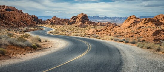 Curving Asphalt Road Through Arid Red Rock Desert Landscape