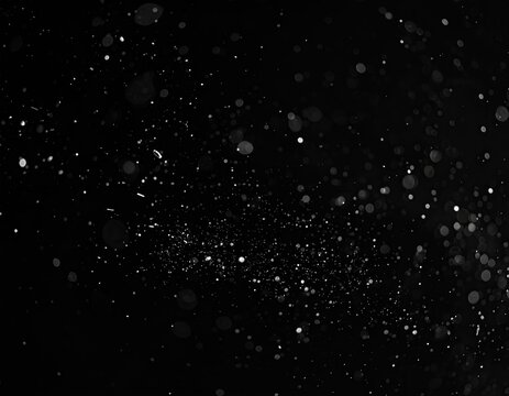 Abstract black background with scattered light particles