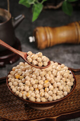 Dry Roasted Chickpeas in Wooden Bowl with Wooden Spoon and Pepper Mill